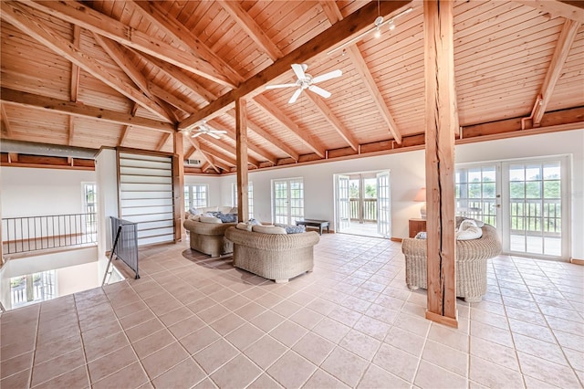 unfurnished living room with tile patterned flooring, ceiling fan, beamed ceiling, wooden ceiling, and high vaulted ceiling