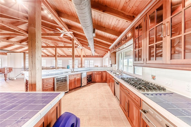 kitchen with vaulted ceiling with beams, wood ceiling, decorative backsplash, tile countertops, and wine cooler