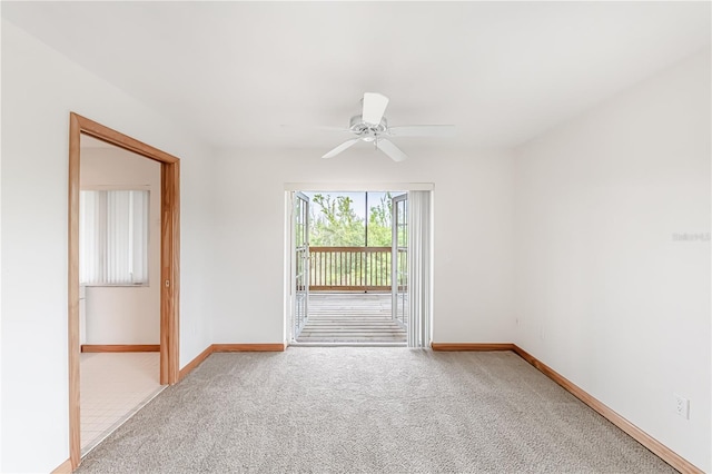 carpeted empty room featuring ceiling fan