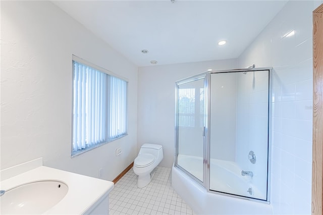 full bathroom featuring vanity, toilet, combined bath / shower with glass door, and tile patterned flooring