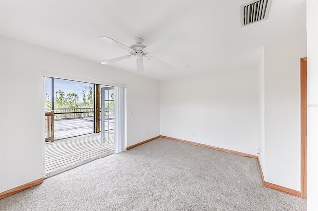 carpeted empty room featuring ceiling fan