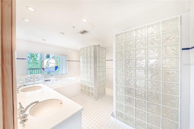 bathroom with tile patterned floors, shower with separate bathtub, and double sink vanity