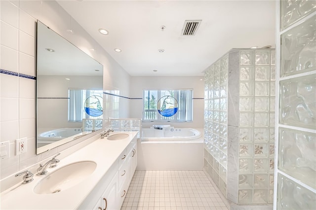 bathroom featuring dual vanity, a bathing tub, tile walls, and tile patterned floors