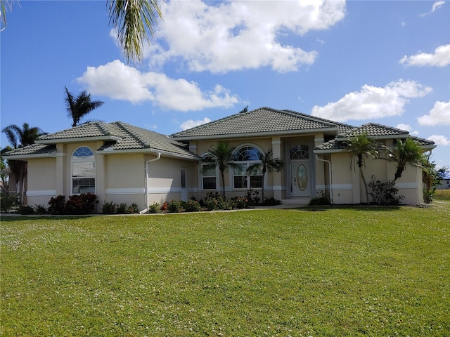 mediterranean / spanish-style house with a front yard