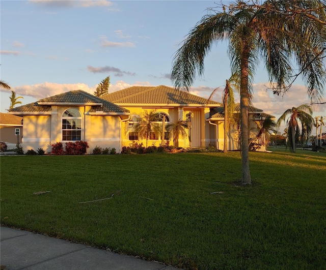 mediterranean / spanish-style home featuring a yard