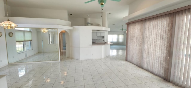 spare room featuring light tile patterned floors and ceiling fan