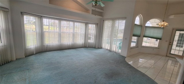 unfurnished sunroom with ceiling fan and plenty of natural light