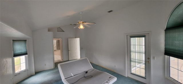 interior space with ceiling fan, a healthy amount of sunlight, high vaulted ceiling, and light carpet