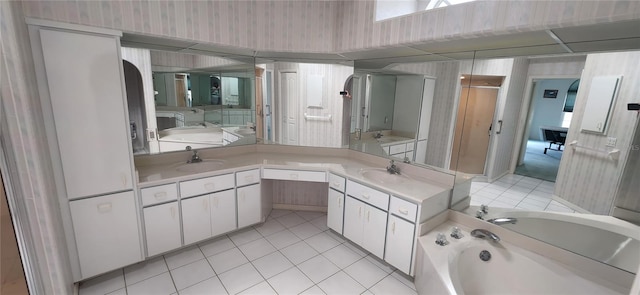 bathroom featuring tile patterned flooring, vanity, and a washtub