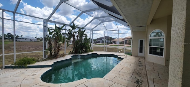 view of swimming pool featuring a patio and a lanai