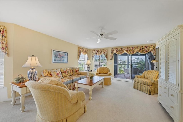 carpeted living room featuring ceiling fan