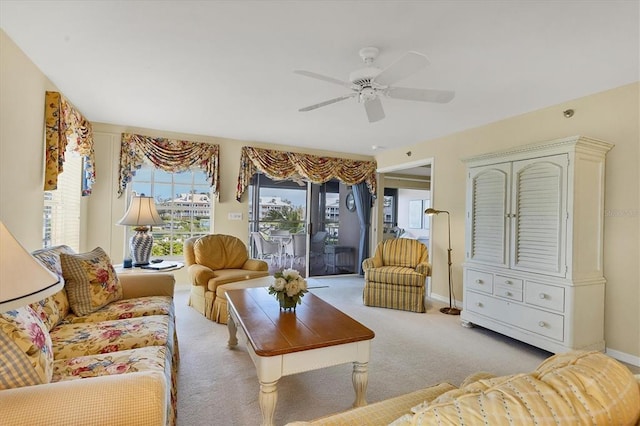 carpeted living room with ceiling fan