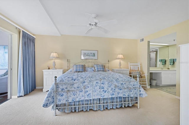 bedroom with light colored carpet, connected bathroom, and ceiling fan