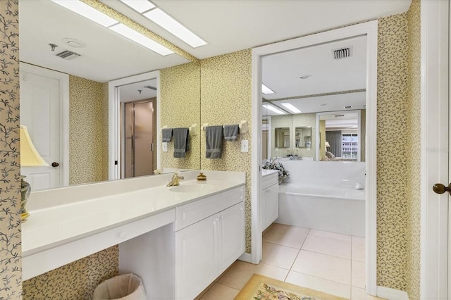 bathroom with a bath, tile flooring, and vanity with extensive cabinet space