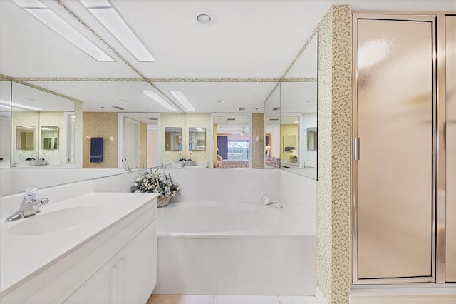 bathroom with shower with separate bathtub, tile floors, and large vanity