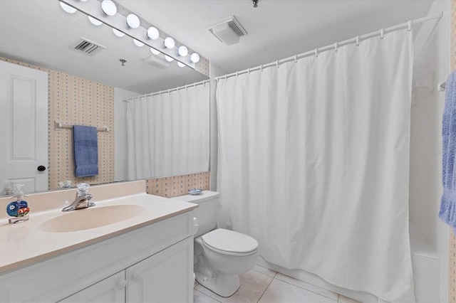 bathroom featuring vanity, tile flooring, and toilet