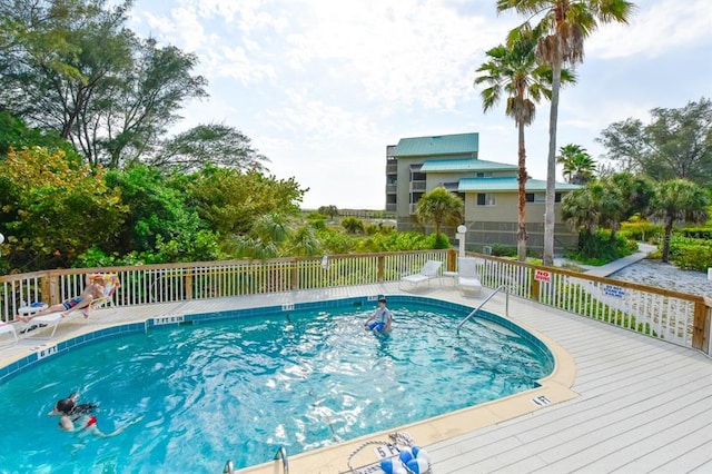 view of swimming pool with a wooden deck