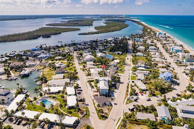 birds eye view of property featuring a view of the beach and a water view