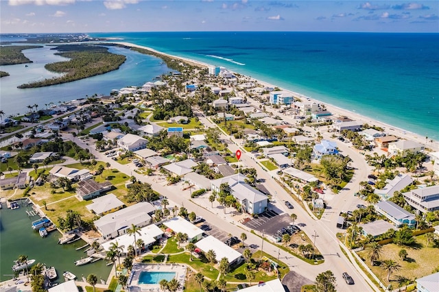 birds eye view of property with a view of the beach and a water view