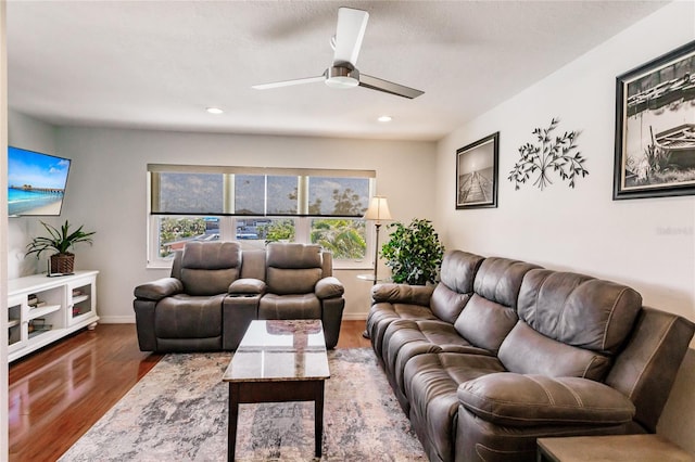 living room with wood-type flooring and ceiling fan