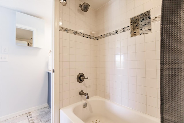 bathroom with tile flooring and tiled shower / bath combo