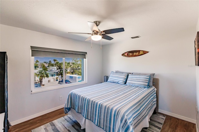 bedroom featuring dark wood-type flooring and ceiling fan