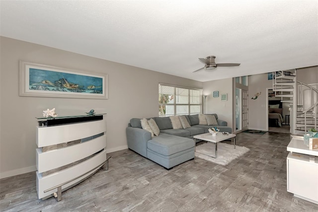 living room featuring light hardwood / wood-style flooring and ceiling fan