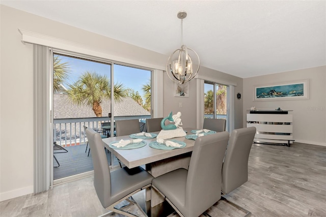 dining space featuring an inviting chandelier and light hardwood / wood-style flooring