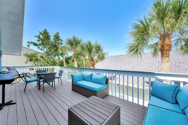 wooden deck with an outdoor living space