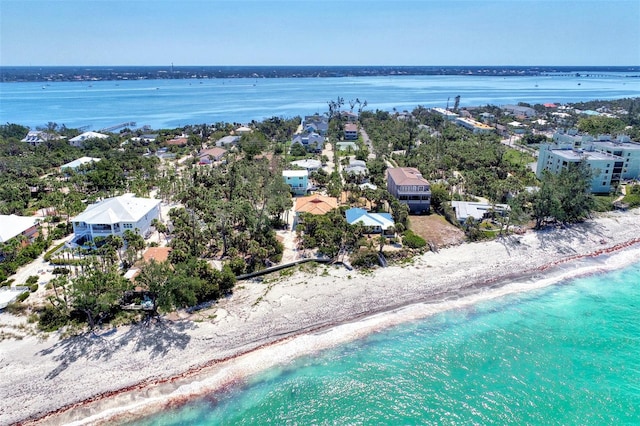 birds eye view of property featuring a beach view and a water view