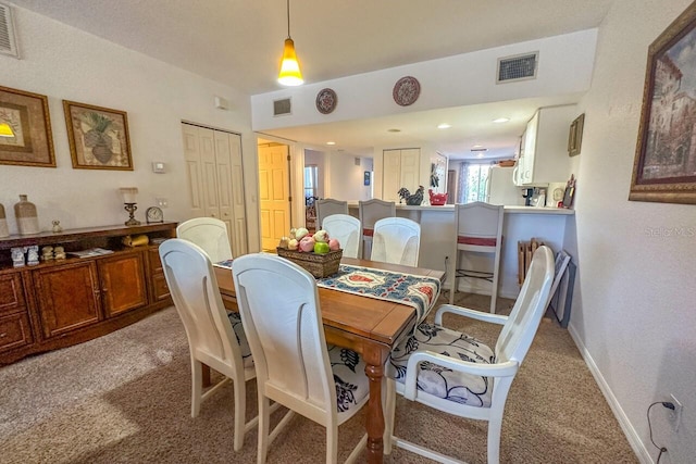 dining room featuring dark carpet