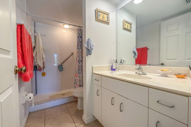 bathroom with vanity, tile flooring, a shower with shower curtain, and toilet