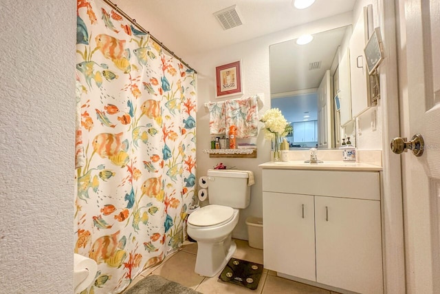 bathroom with toilet, tile flooring, and large vanity