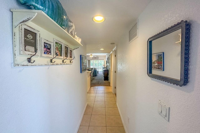 corridor featuring light tile floors