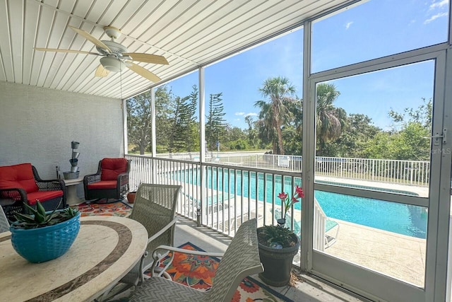 sunroom / solarium featuring plenty of natural light and ceiling fan