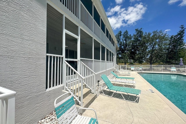 view of swimming pool featuring a patio area