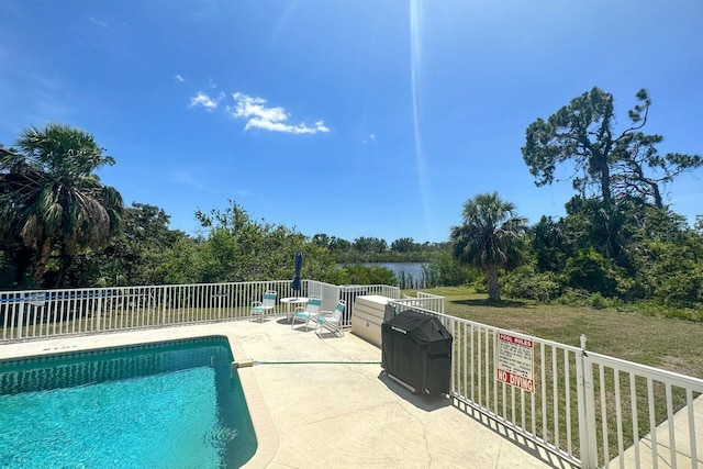 view of swimming pool with a lawn and a patio