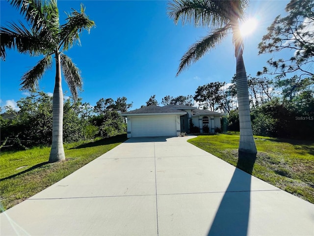 view of front of home featuring a front lawn and a garage