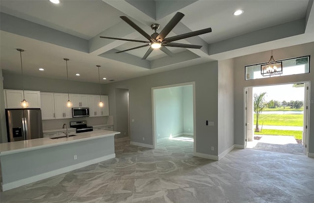 kitchen with white cabinetry, ceiling fan with notable chandelier, light tile flooring, appliances with stainless steel finishes, and sink