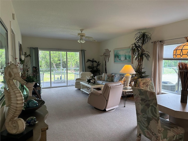 carpeted living room featuring ceiling fan