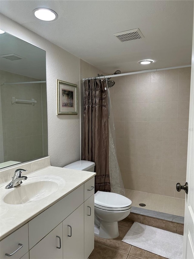 bathroom featuring curtained shower, toilet, large vanity, and tile floors