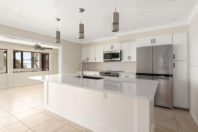 kitchen with white cabinets, backsplash, stainless steel appliances, sink, and ceiling fan