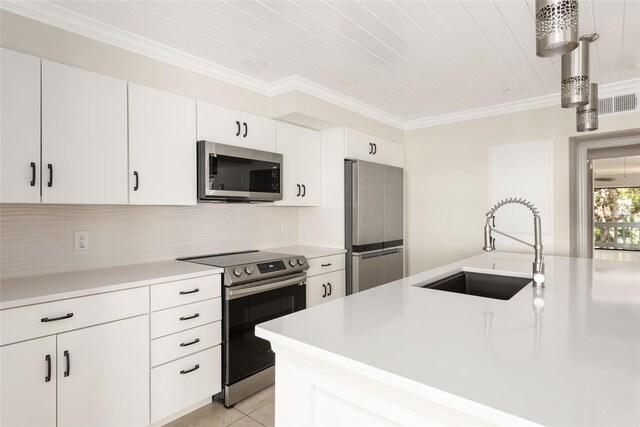 kitchen with sink, backsplash, white cabinetry, stainless steel appliances, and ornamental molding