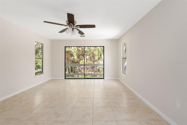 tiled spare room featuring ceiling fan