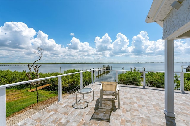 view of patio with a water view