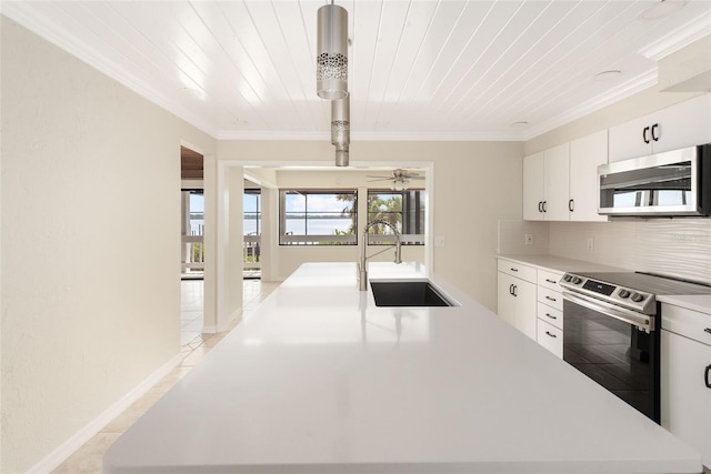 kitchen featuring backsplash, stainless steel appliances, white cabinets, sink, and light tile floors