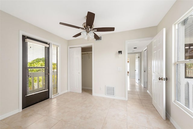 unfurnished bedroom featuring ceiling fan and light tile floors