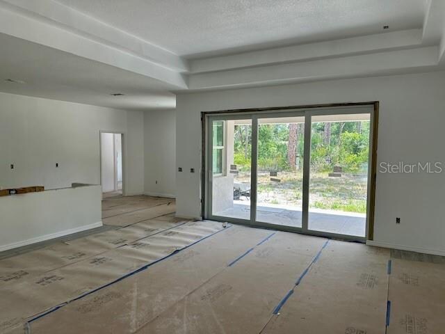 unfurnished room featuring a textured ceiling