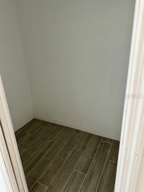 unfurnished room featuring dark wood-type flooring