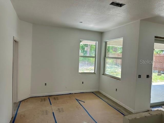 empty room featuring a textured ceiling